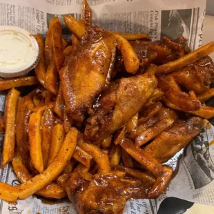 Homemade bbq on top of wings and fries