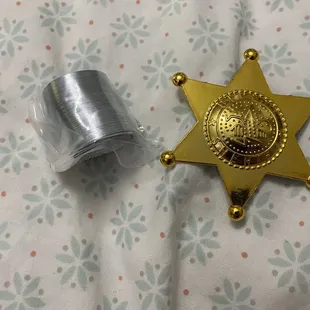 Metal slinky and plastic badge prize