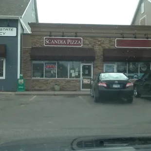 a car parked in front of a restaurant