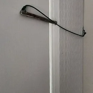 Look at the "deadbolt". A metal rod attached by string that goes about 1/4" into a hole.  Ridiculous