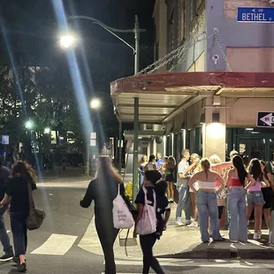 The club is to the left on the right are the people selling wristbands to the college kids.