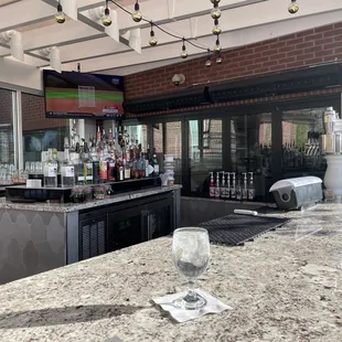 Nice outside bar with a TV playing sports