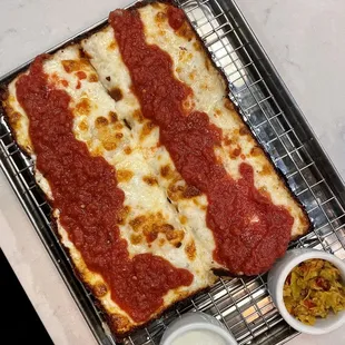 a square pizza on a cooling rack