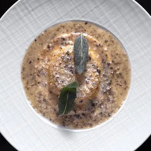 Raviolo with truffle, sheep&apos;s milk ricotta, truffle butter sage