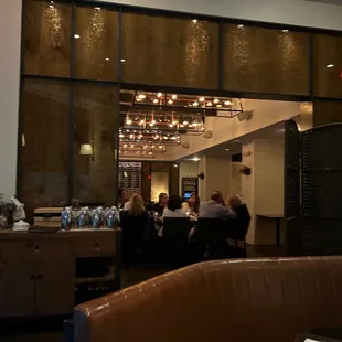 a group of people sitting at a table in a restaurant