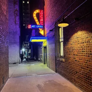 a neon sign in a dark alley