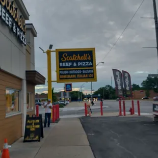 a man standing in front of a restaurant