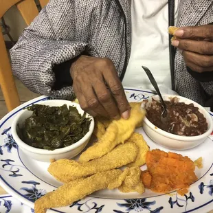 Catfish meal with greens and red beans and rice