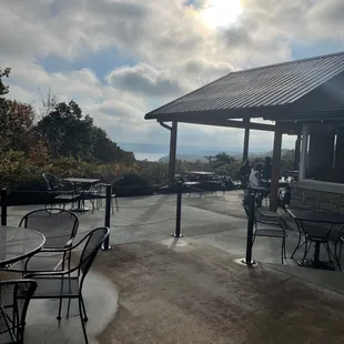 a patio with tables and chairs
