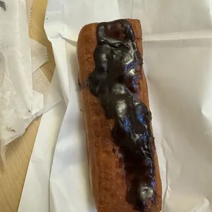 Chocolate long John with cream filling. The filling is always full and delicious, however the chocolate is always like this or worse.