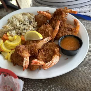 Coconut Shrimp with truffle potatoes au gratin and sautéed vegetables.