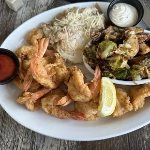 Fried shrimp with truffle potatoes au gratin and Crispy Brussels Sprouts.