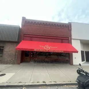 a scooter parked in front of the restaurant