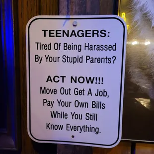 a sign that reads teenagers tired of being harased by your stupid parents act now move out get a job pay your