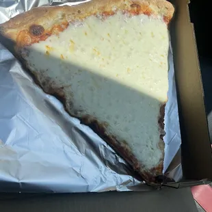 a slice of cheese pizza in a box