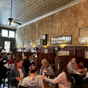 people sitting at tables in a restaurant
