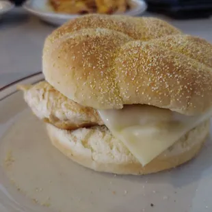 Grilled chicken breast sandwich with slice of processed swiss