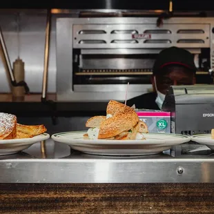 three plates of pastries on a counter