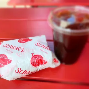 a cup of coffee and a bag of snacks