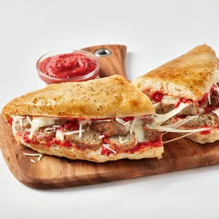 a meatball sandwich on a cutting board