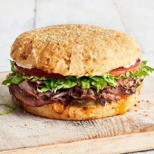 a beef sandwich with lettuce and tomato