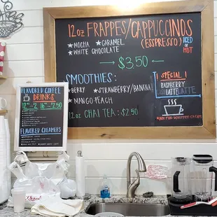 A menu board behind the counter showing the drinks.