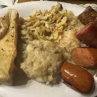 Sausage Sampler with German Potato Salad, Sauerkraut, and Spatzle.