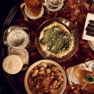 Puff pastry pizza, white bean cacio e Pepe, bread with tomatoes, and le petit fizz