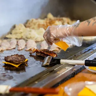 a person preparing food on a grill