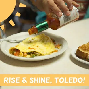 a person pouring ketchup onto a plate of food