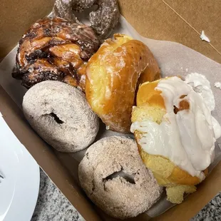 Chocolate Glaze, apple fritter, glaze, cinnamon roll, cinnamon powder donuts.