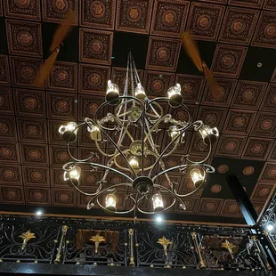 Beautiful chandelier with copper ceiling tiles