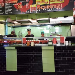 a man behind the counter of a restaurant