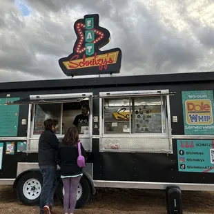 two people ordering food from a food truck