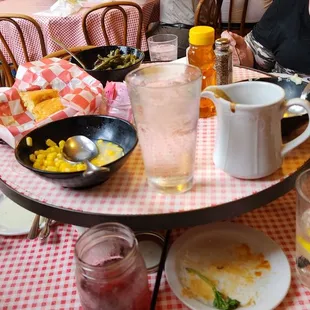 This is the table with a lazy Susan in the middle with the family style sides, mashed potatoes, green beans, and corn.