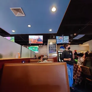 a man standing in the corner of a restaurant