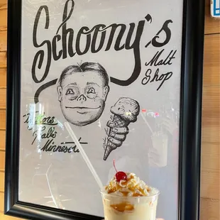 a hand holding a cup of ice cream