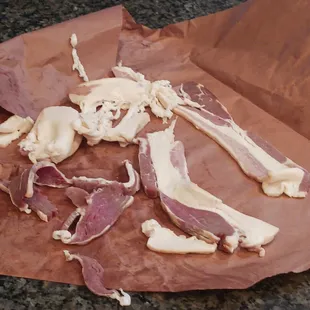 a piece of bacon on a piece of wax paper