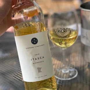 a person holding a bottle of wine