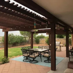 a patio with a table and chairs