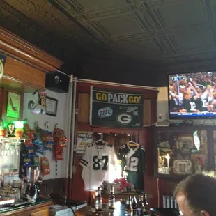 a man sitting at a bar watching a football game