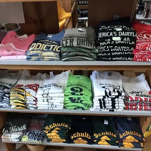 a shelf of t - shirts