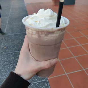 Rocky road malt milkshake with whipped cream