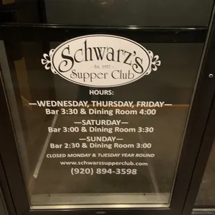 Front door with hours.