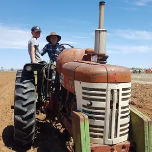 two men on a tractor