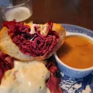 Deutsch Dip. Our take on the French Dip. Beer Braised Onions, Muenster Cheese, and House Made Beef Au Jus