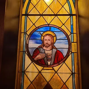 Stained glass window with an image of Jesus Christ.