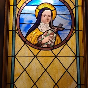Stained glass window with an image of Mary Magdalene (I believe).