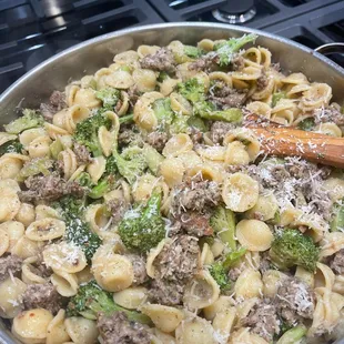 a skillet of pasta and broccoli