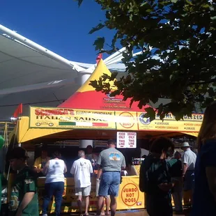 a crowd of people at a food stand